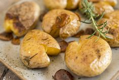 mushrooms on a plate with rosemary sprig in the middle and other food items