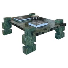 a green marble coffee table with books on top