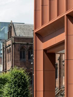 an orange building with a clock tower in the background