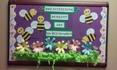 the bulletin board is decorated with paper flowers and beehive cutouts on it