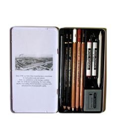 an open book with pencils and pens in it