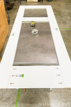 an unfinished table being worked on in a garage