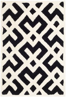 a black and white rug with an abstract design