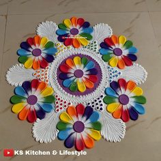 colorful paper flowers are arranged on the floor