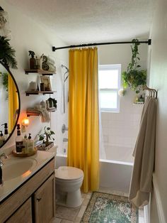 a bathroom with yellow curtains and white fixtures