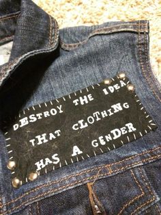 a patch on the back of a jean jacket that says destroy the idea that clothing has a gender