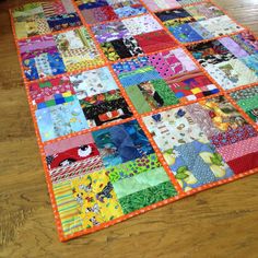 a colorful patchwork quilt is laying on the floor