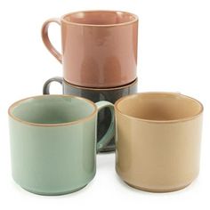 four different colored coffee mugs sitting next to each other