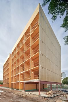 a large wooden building sitting on top of a dirt field