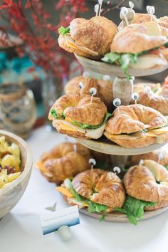 there are sandwiches and other food items on the table for desserts to be eaten