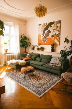 a living room with green couches and rugs on the floor in front of a window