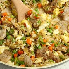 a pan filled with rice, meat and vegetables