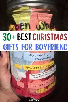 a person holding up a jar filled with colorful paper and the words best christmas gifts for boyfriend