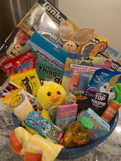 a basket filled with toys and snacks on top of a counter