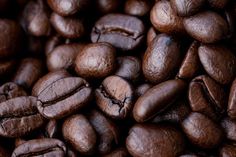 coffee beans are shown close up on a table