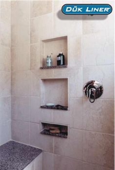 there is a shower with shelves on the wall