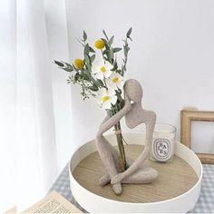 a vase with flowers in it sitting on a table