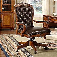 a brown leather office chair sitting on top of a rug in front of a desk