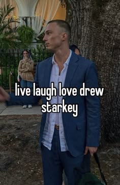 a man in a blue suit and white shirt with the words live laugh love draw starkey