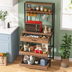 three tiered kitchen storage rack with pots, pans and utensils