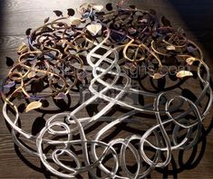 several metal wire sculptures sitting on top of a wooden table