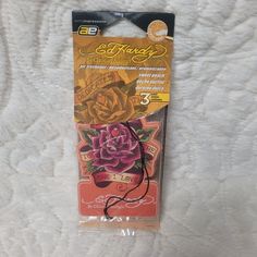 the package is packaged in plastic and has a rose on it