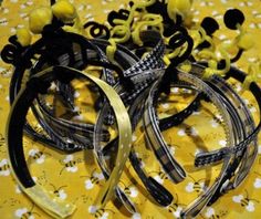 several pieces of black and yellow hair clips on a tablecloth with flowers in the background