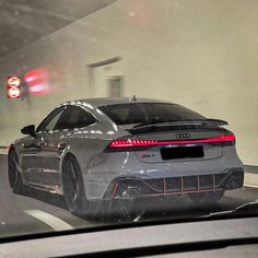 the rear end of an audi car driving through a tunnel