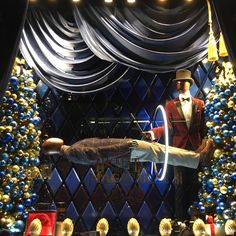 a window display with mannequins dressed in tuxedos