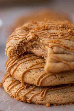 a stack of cookies covered in peanut butter and drizzled with icing