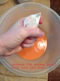 a hand holding an egg in a bowl with the words squeeze the excess paint back into the bowl