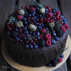 a chocolate cake topped with berries and blueberries