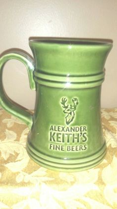 a green beer mug sitting on top of a table