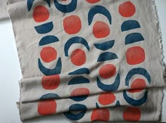 a piece of cloth with red, white and blue circles on it sitting on a table