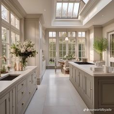 a large kitchen with an island and skylight in it's center window area