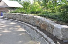 a stone wall in front of a building