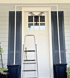 a step ladder sitting in front of a white door