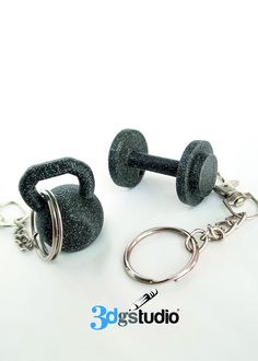 two black dumbbells with chains attached to them