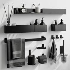 black and white bathroom accessories displayed on wall