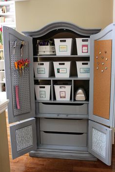 an armoire with lots of bins in it