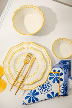 yellow and blue place settings on a white table