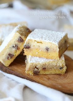 three pieces of cake sitting on top of a wooden cutting board