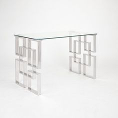 a glass and metal table with squares on it's sides, against a white background