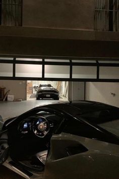 a car is parked in a garage with the door open to reveal it's interior