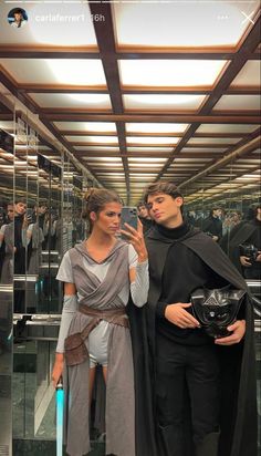 two people dressed up as darth vader and princess leida are taking pictures