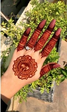 a hand with henna tattoos on it