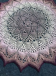 a crocheted doily is laying on the floor