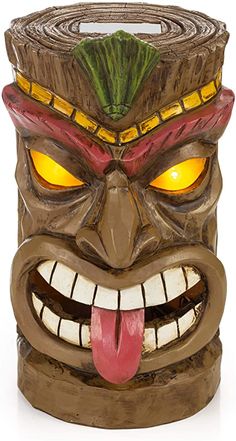 a tiki mask with glowing eyes and tongue sticking out