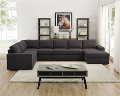 a living room with a sectional couch and coffee table