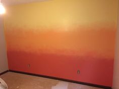 an orange and yellow painted wall in a room